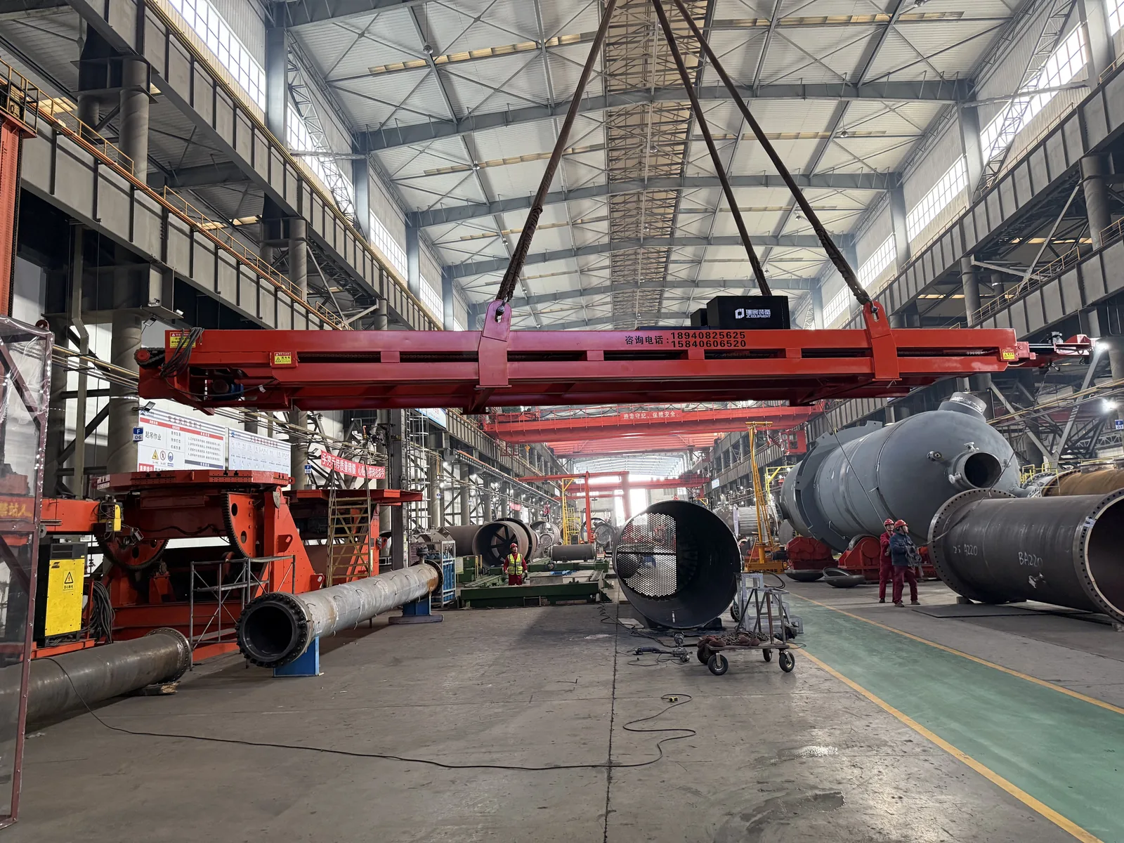 Tube bundle extractor lifting frame being handled in a heat exchanger manufacturing workshop